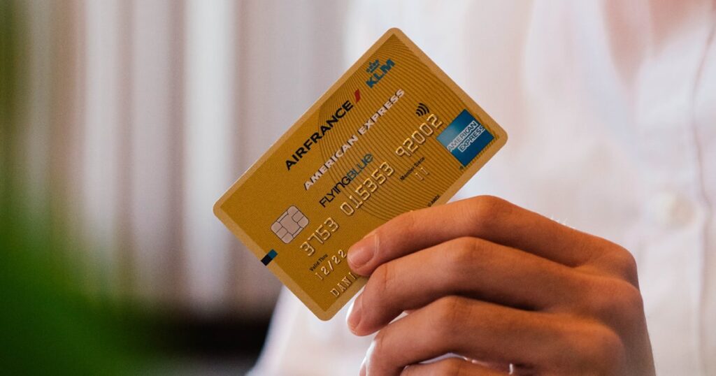 Hand holding multiple credit cards — best options for new immigrants in the USA